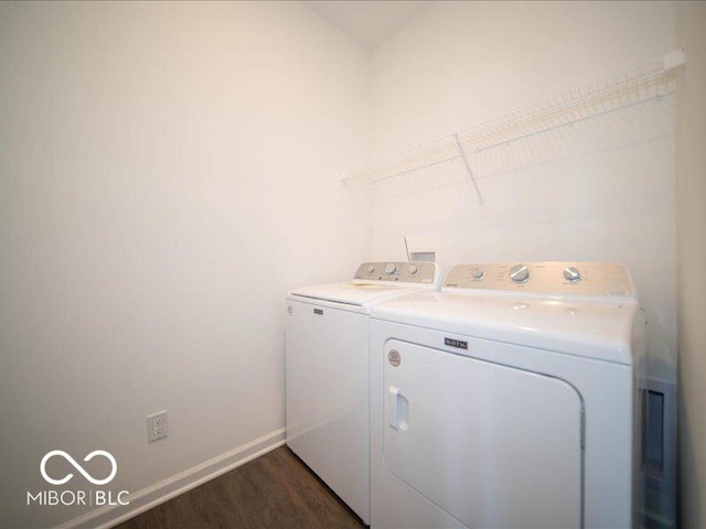 washroom with separate washer and dryer and dark hardwood / wood-style floors