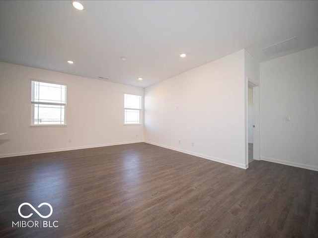 spare room with dark wood-type flooring