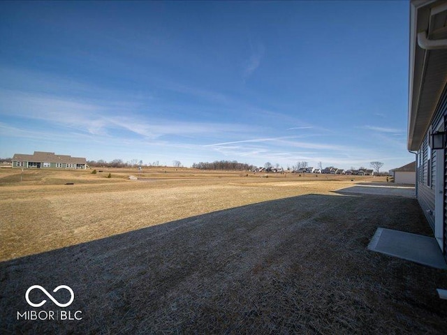 view of yard with a rural view