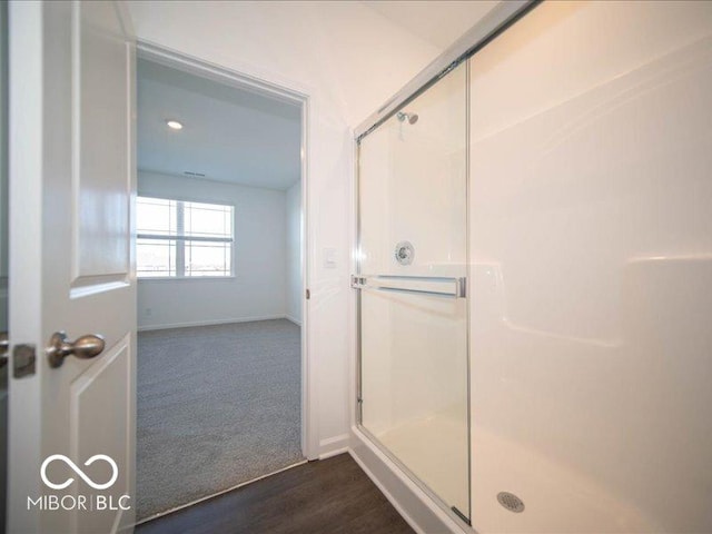 bathroom featuring hardwood / wood-style floors and an enclosed shower