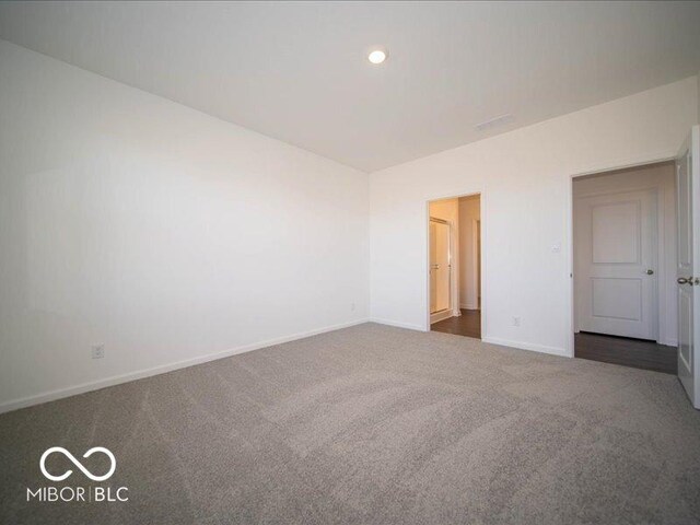 unfurnished bedroom featuring dark colored carpet