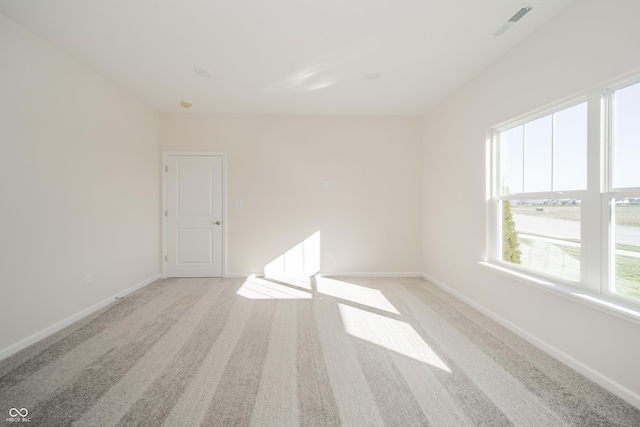 unfurnished room with light carpet