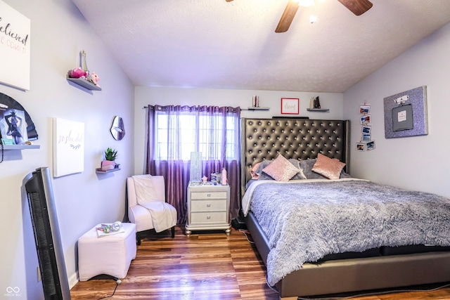 bedroom with ceiling fan, hardwood / wood-style floors, and a textured ceiling