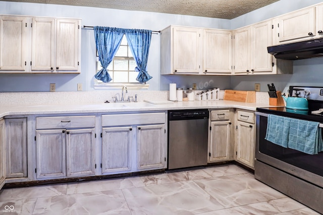 kitchen with stainless steel appliances, a textured ceiling, and sink