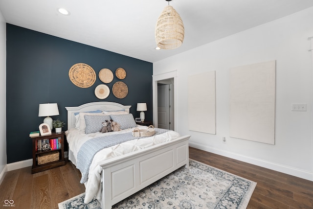 bedroom with dark hardwood / wood-style floors