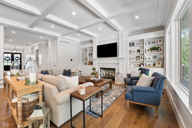 living room featuring hardwood / wood-style flooring, a fireplace, coffered ceiling, and plenty of natural light