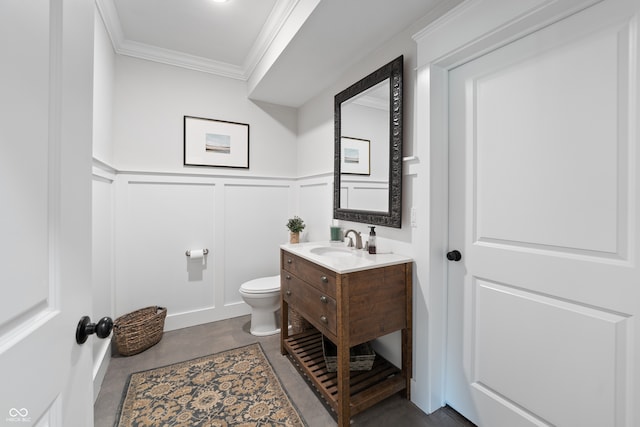 bathroom featuring crown molding, vanity, and toilet