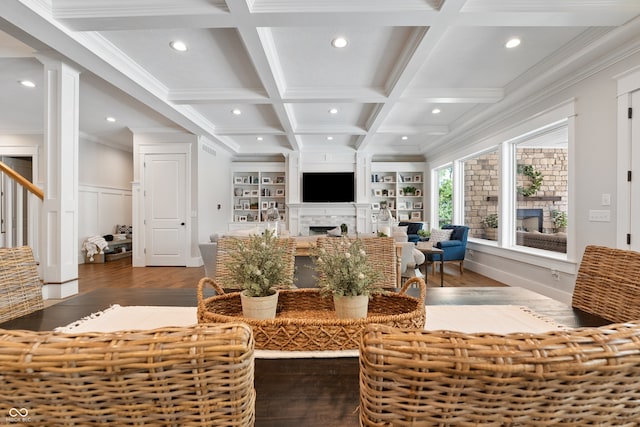 living room featuring coffered ceiling, beamed ceiling, built in features, ornamental molding, and hardwood / wood-style floors