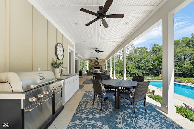 view of patio / terrace with area for grilling, an outdoor living space, grilling area, ceiling fan, and sink