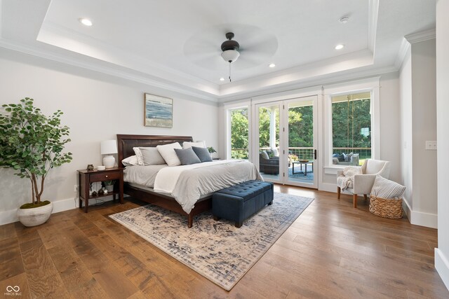 bedroom featuring a raised ceiling, dark hardwood / wood-style flooring, ceiling fan, and access to exterior