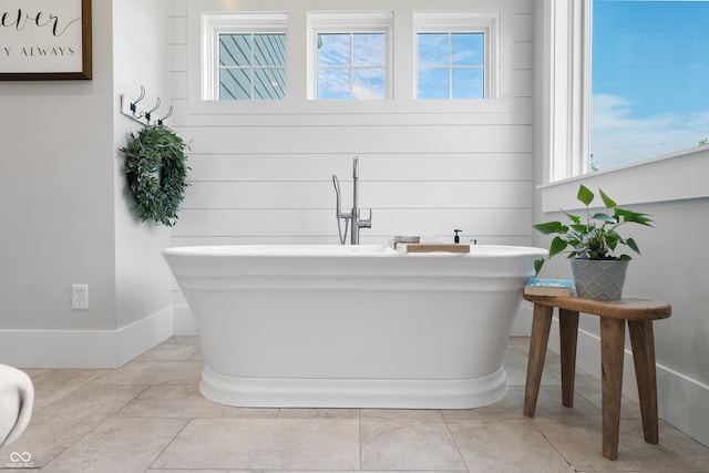 bathroom featuring tile patterned floors and a tub