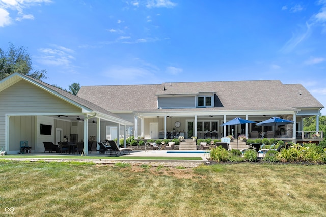 rear view of house featuring a lawn, ceiling fan, and a patio area