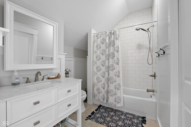 full bathroom featuring shower / bath combination with curtain, vanity, lofted ceiling, toilet, and tile patterned flooring