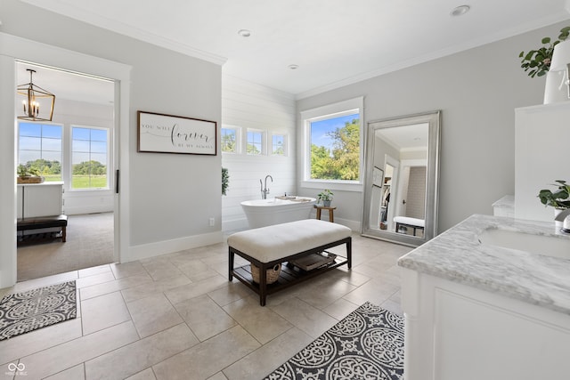 bedroom featuring multiple windows, sink, and crown molding