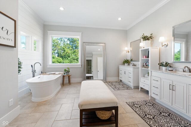 bathroom featuring a tub to relax in, wood walls, vanity, crown molding, and tile patterned floors