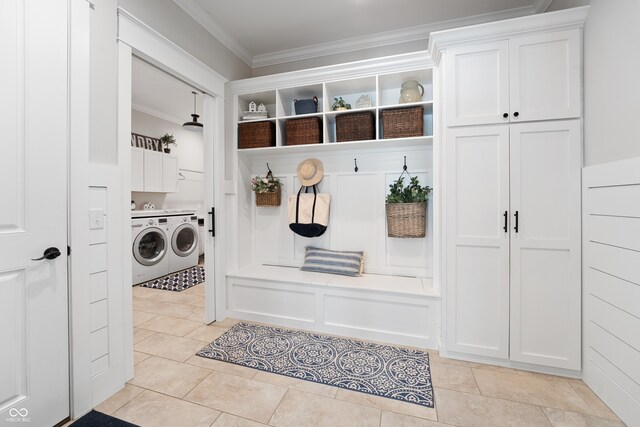 mudroom featuring crown molding, separate washer and dryer, and light tile patterned floors