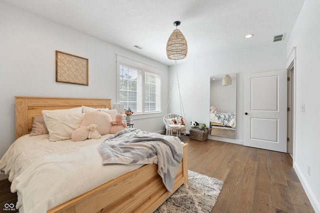 bedroom with dark wood-type flooring