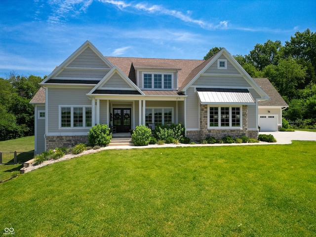 craftsman-style home featuring a front lawn, a porch, and a garage