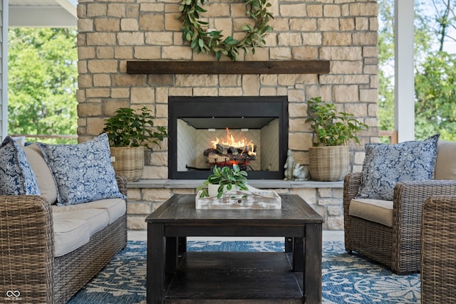 view of patio with an outdoor living space with a fireplace