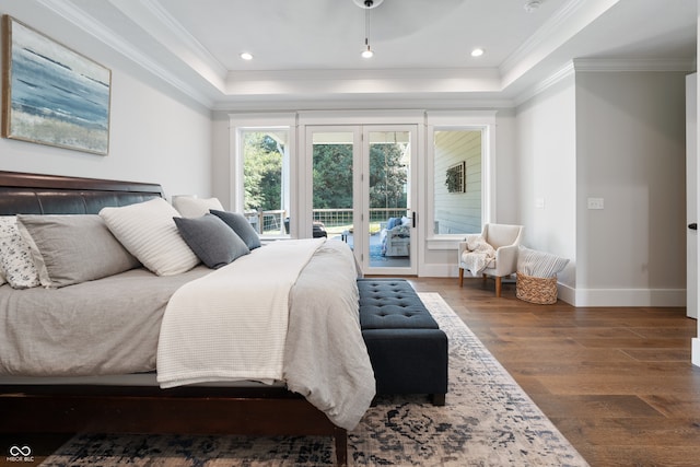 bedroom with access to outside, a tray ceiling, ornamental molding, and dark wood-type flooring