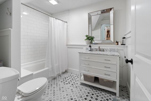 full bathroom with vanity, shower / bath combo with shower curtain, toilet, and tile patterned floors