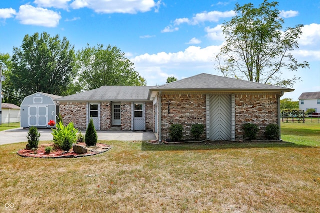 single story home with a front yard and a storage shed