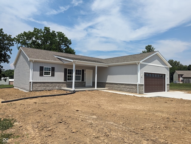 single story home with a garage and covered porch