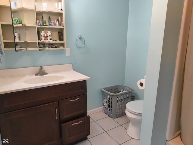 bathroom featuring tile patterned flooring, vanity, and toilet