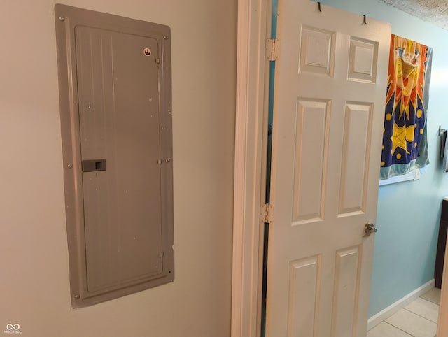 hallway featuring light tile patterned floors and electric panel