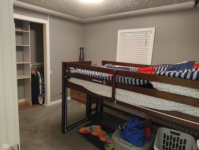 bedroom featuring ornamental molding, carpet floors, a textured ceiling, and a closet