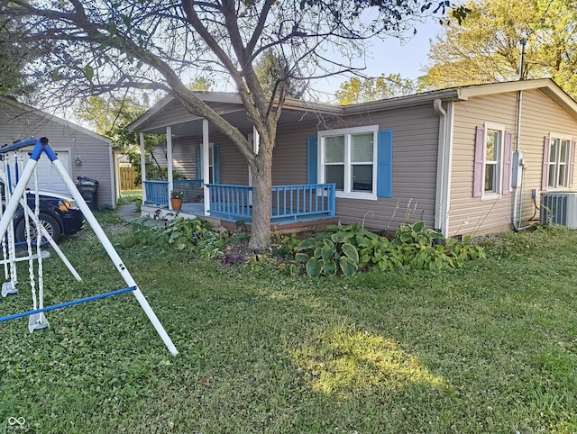 rear view of house featuring a yard, central AC, and covered porch