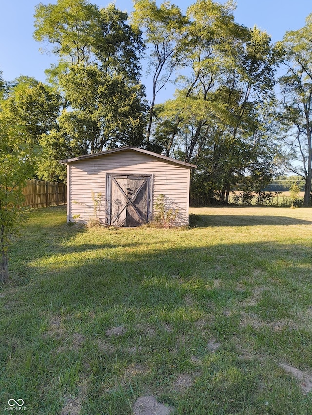 view of outdoor structure featuring a lawn