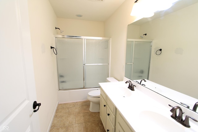 full bathroom featuring vanity, shower / bath combination with glass door, and toilet