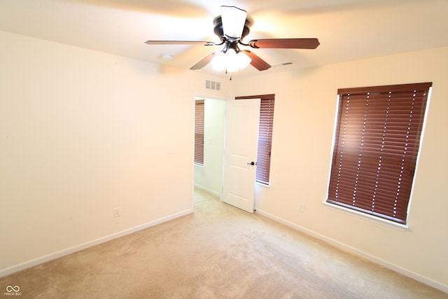 unfurnished bedroom featuring light colored carpet and ceiling fan