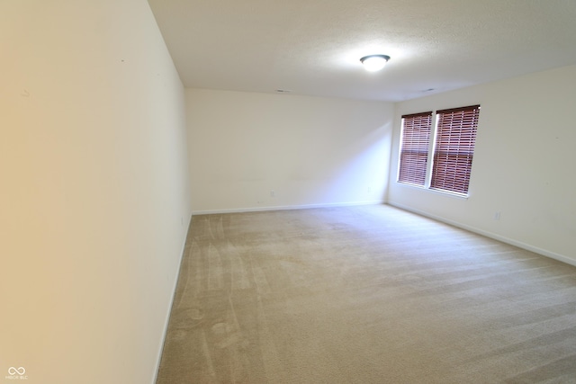 carpeted spare room featuring a textured ceiling