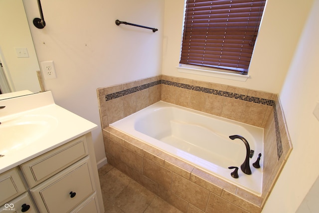 bathroom featuring vanity and tiled bath