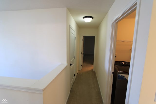 hall with washer / dryer and carpet flooring