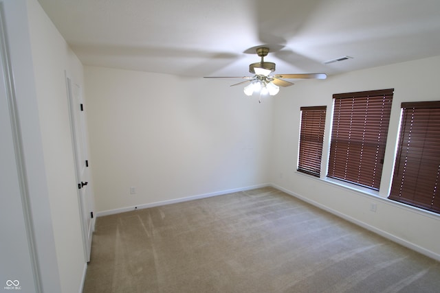 carpeted empty room featuring ceiling fan