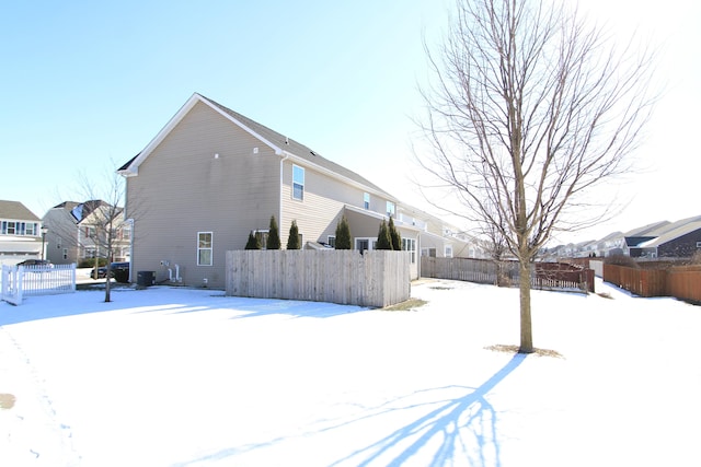 view of snow covered rear of property