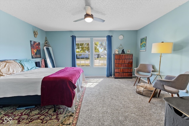 bedroom featuring ceiling fan, light colored carpet, and a textured ceiling