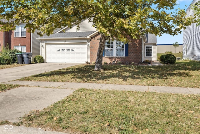 view of front of house with a front yard and a garage