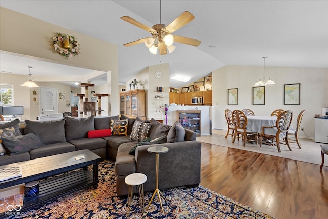 living room featuring light wood-type flooring, lofted ceiling, and ceiling fan