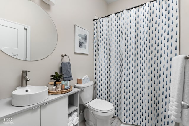 bathroom featuring vanity, toilet, and a shower with curtain