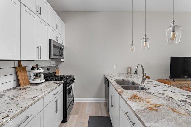 kitchen featuring white cabinetry, light hardwood / wood-style floors, appliances with stainless steel finishes, and sink