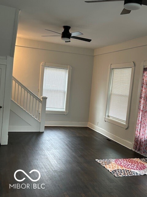 spare room with ceiling fan and dark wood-type flooring