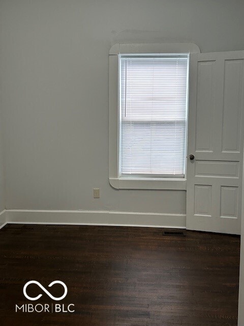 spare room featuring dark hardwood / wood-style flooring