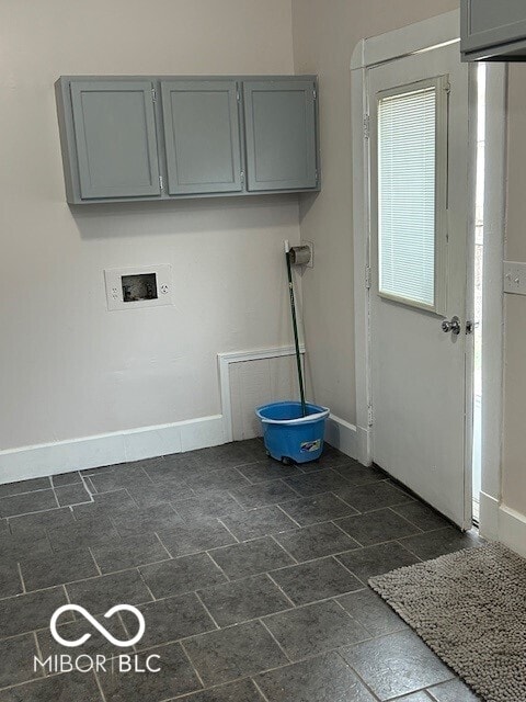 laundry room featuring hookup for a washing machine and cabinets