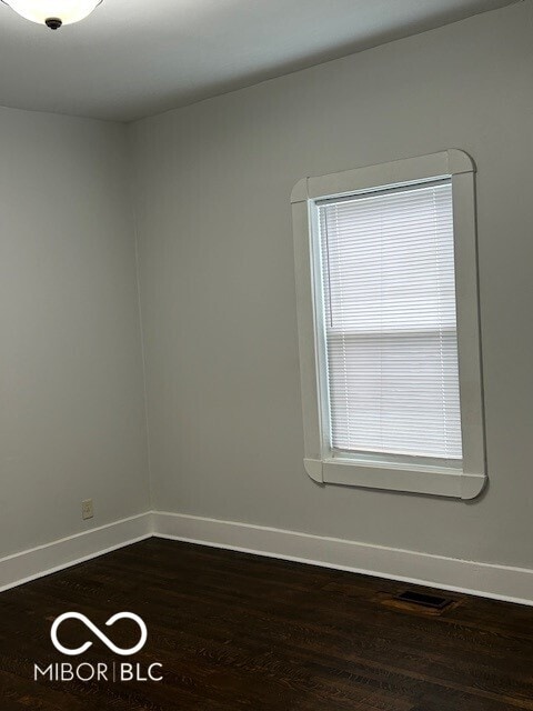 empty room with dark wood-type flooring