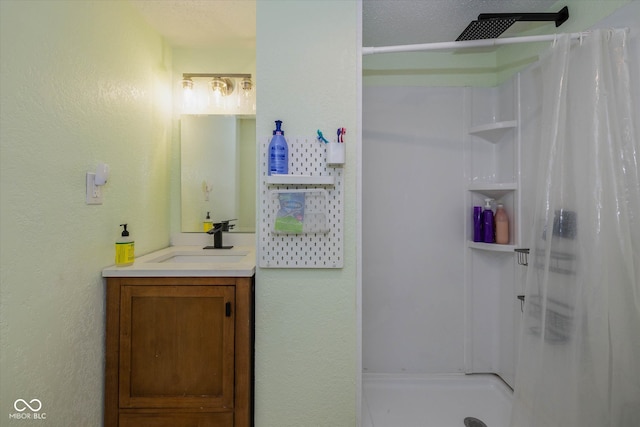 bathroom featuring vanity and curtained shower