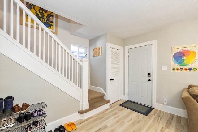 foyer with a textured ceiling and hardwood / wood-style floors